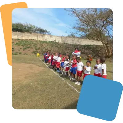 Preschool children lined up on the start line on a field.